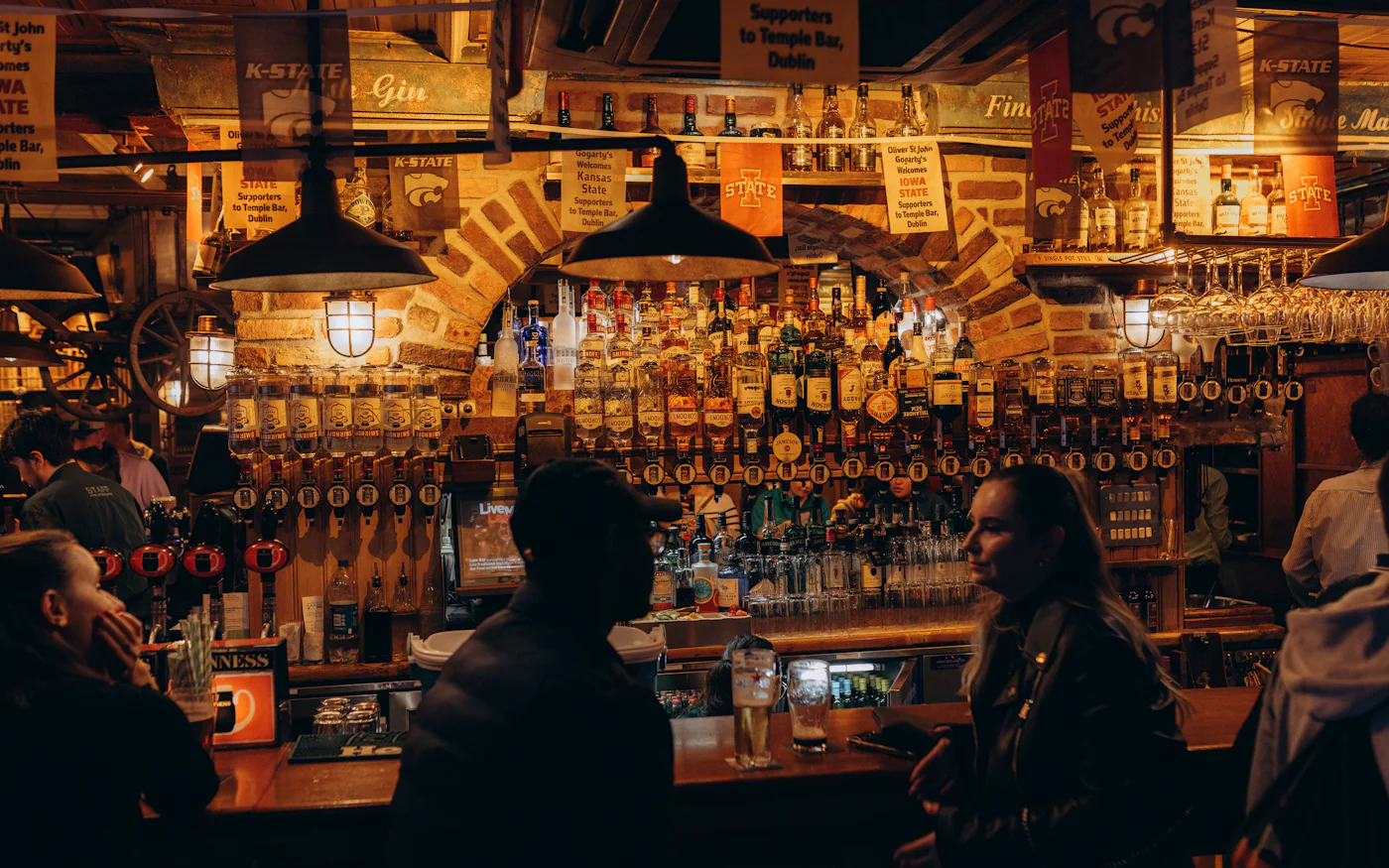 Guests gathered at a busy bar with beer taps