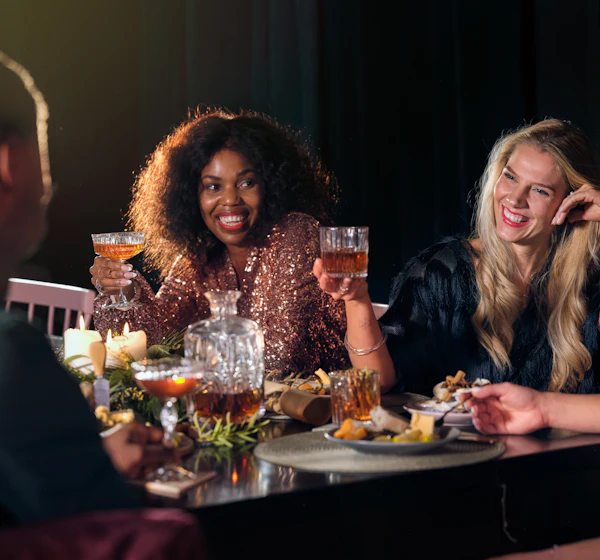 Friends laughing over dinner and drinks