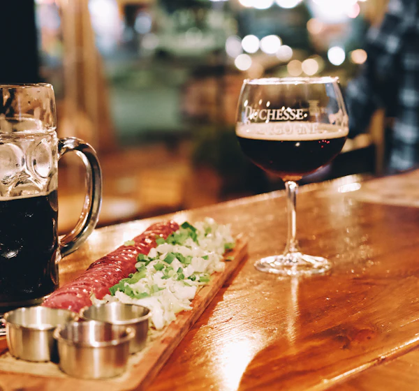 Pint of beer on a wooden bar