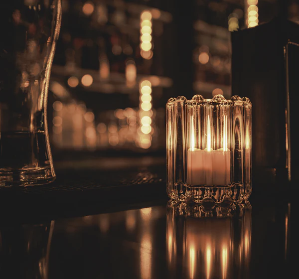 Candle glowing on the bar counter