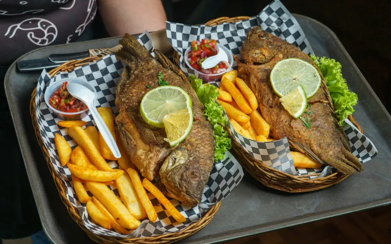 Fried whole fish with fries and lime