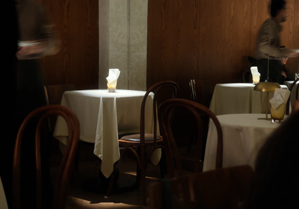 Warmly lit dining room with set tables